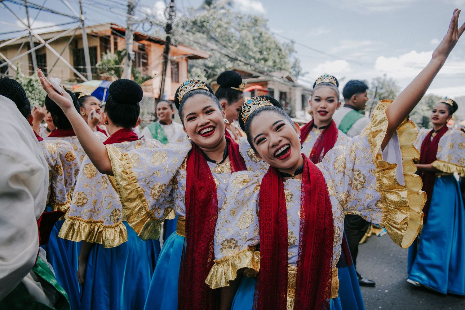 Festival performers in colorful traditional costumes dancing and celebrating together.