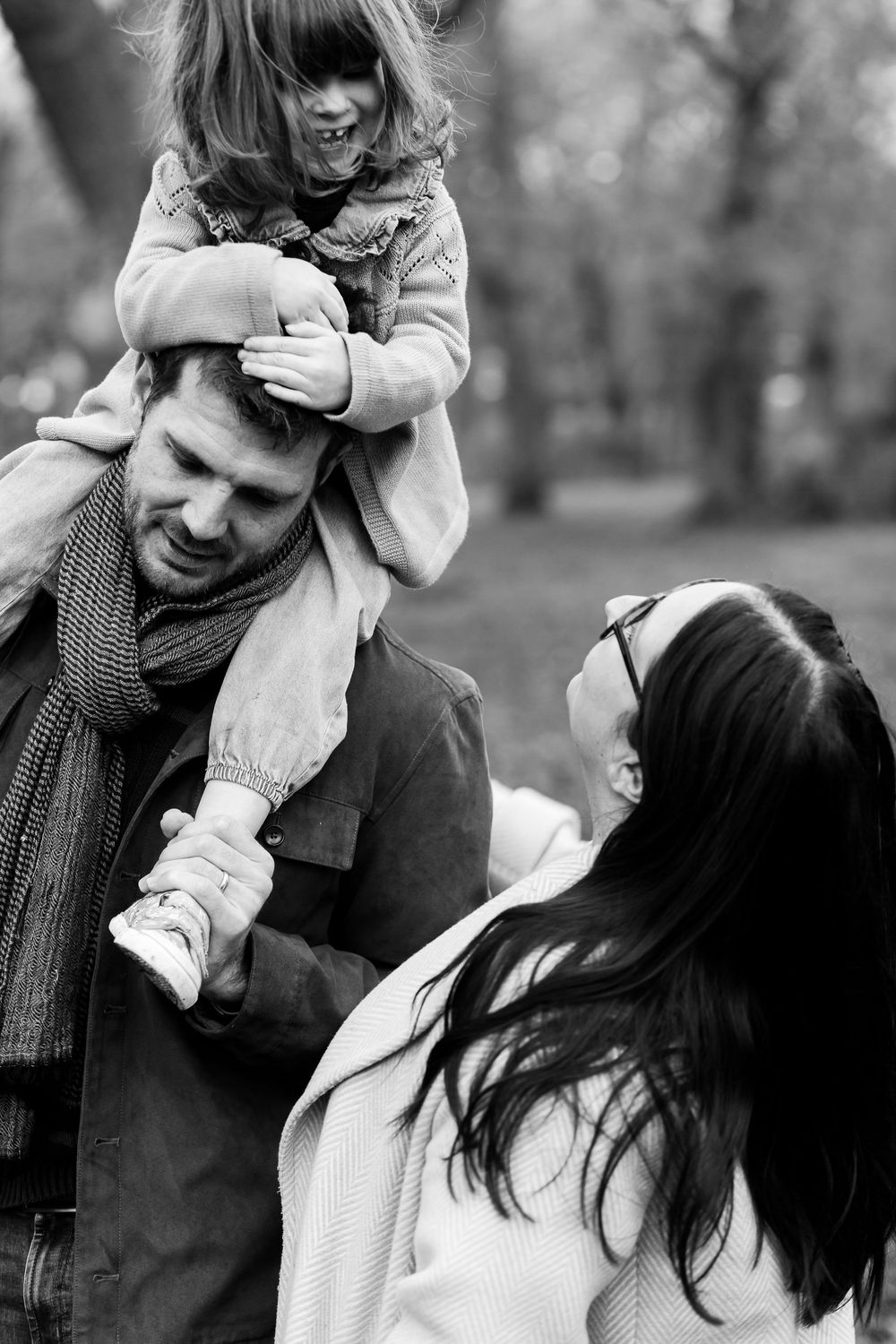 Black and white photos show a couple sharing playful and romantic moments together outdoors.