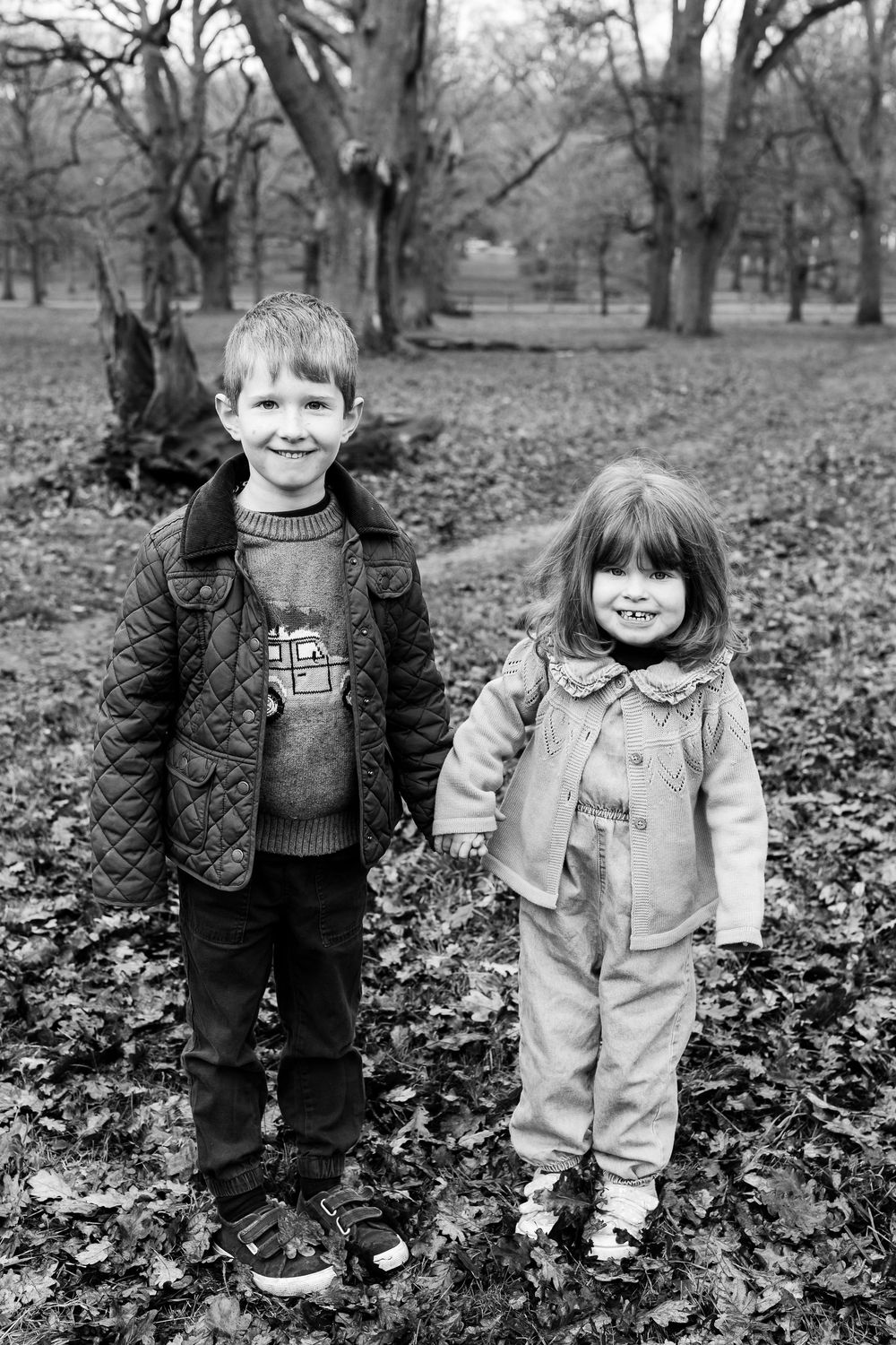 A black and white photo sequence shows children playing and posing among fallen autumn leaves in a park.