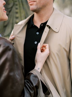 A person wearing a beige suit jacket and black shirt adjusts their lapel in a series of cropped photos.