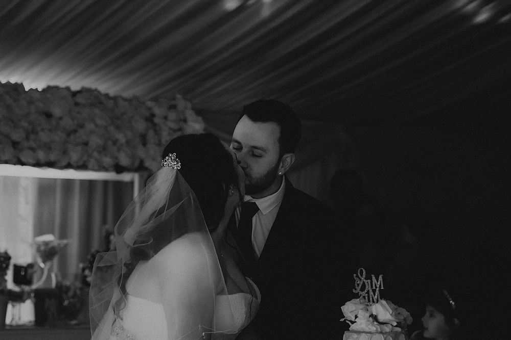 A black and white wedding photo montage showing romantic moments between newlyweds in various poses.