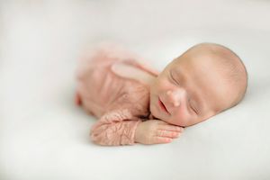 Newborn baby on neutral blanket on white background – Springfield MO.