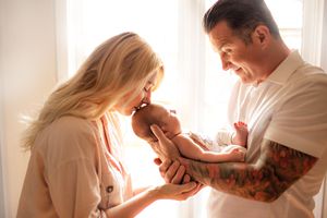 Family cuddling newborn in natural light – Springfield Missouri.
