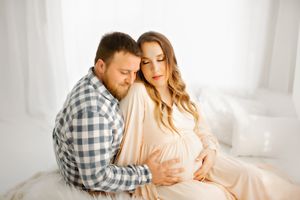 Couple embracing during maternity session in Springfield Missouri.