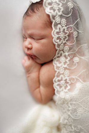 Natrual light newborn portrait wrapped in lace and cream tones - Springfield Missouri Newborn Photographer.