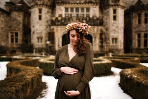 Maternity portrait in front of castle with flower crown - Springfield Missouri Photographer.