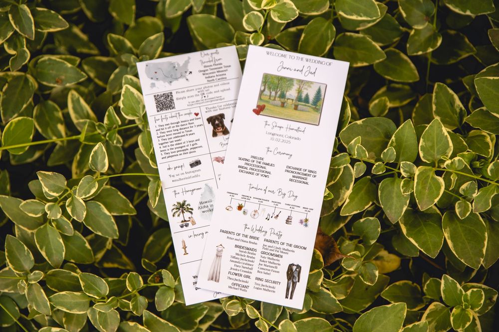 Two wedding program booklets displayed on green variegated foliage background.