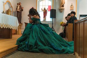 Panoramic view of church interior during ceremony with green-dressed celebrant.