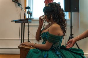 Close-up shots of ceremony participants in church with person wearing emerald formal attire.