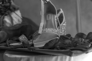 Black and white detail shot of formal dress accessories and decorations.