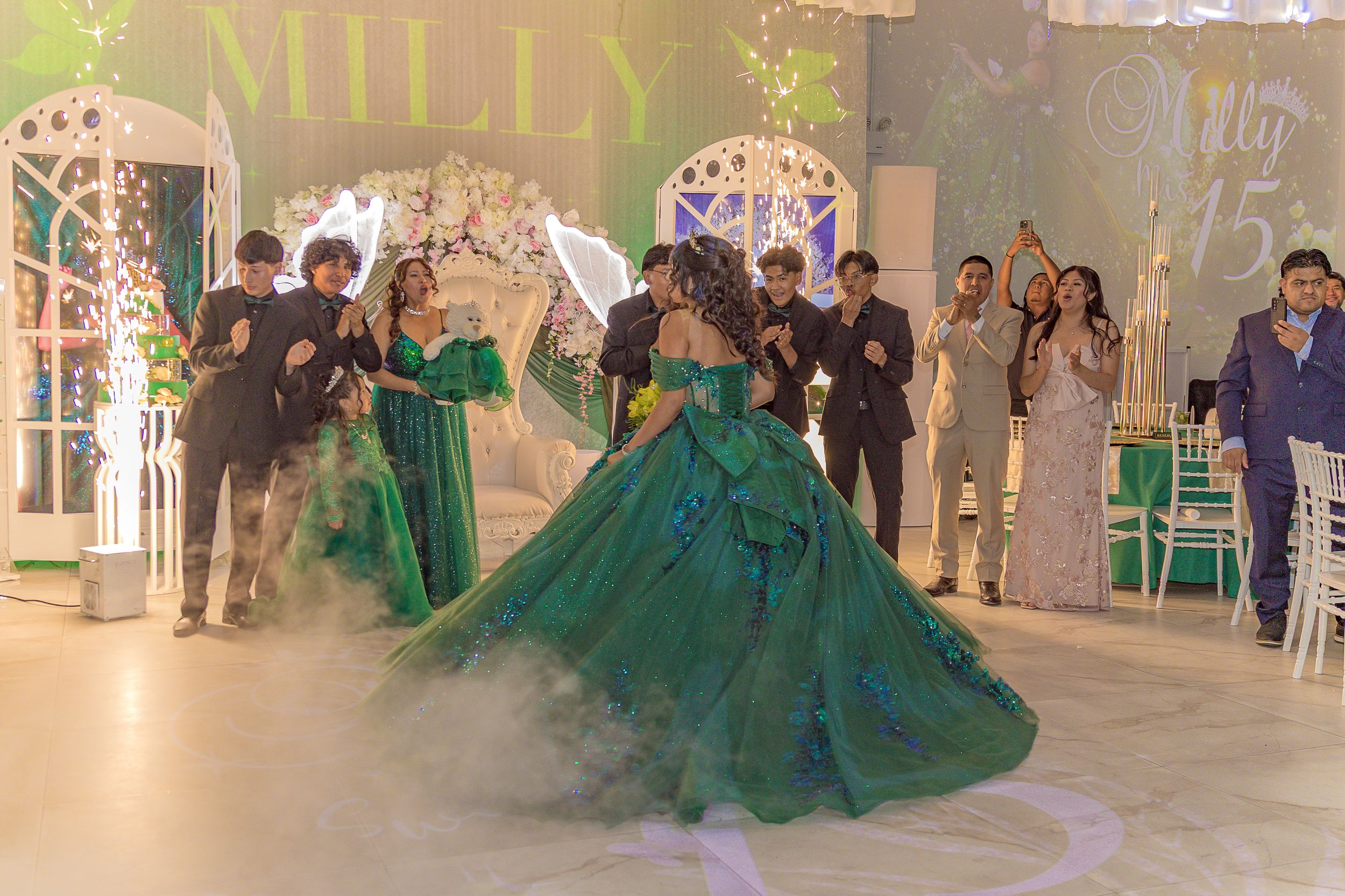 An elegant event space with green decorative elements and white lattice panels.