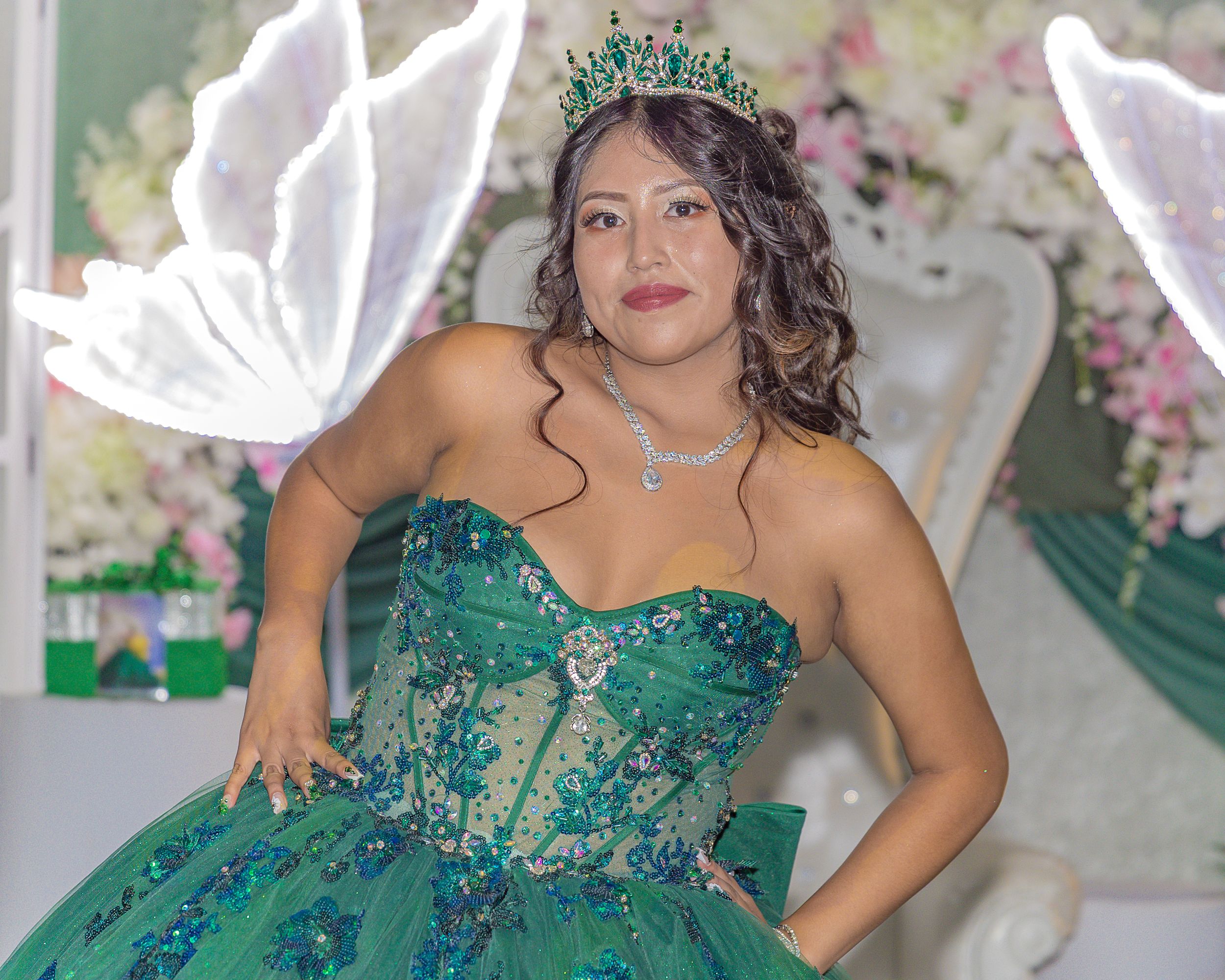 An elegant celebration featuring emerald green formal wear and floral decorations.