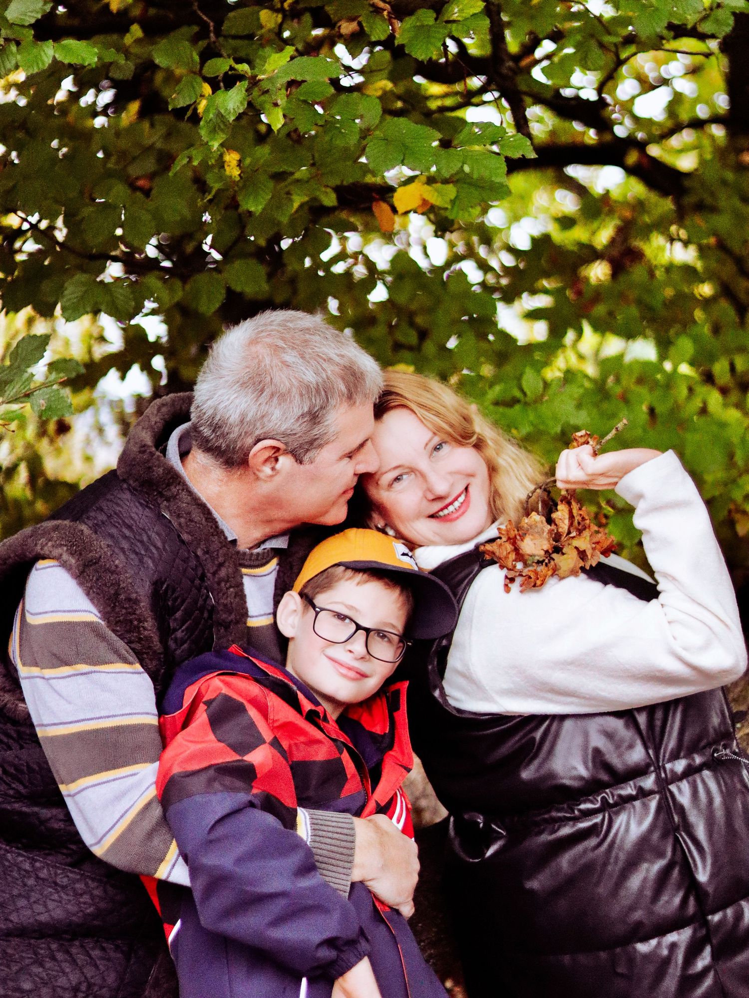 Two happy parents  a couple and their beloved child  are feeling relaxed in front of the camera. Perfect family shoot