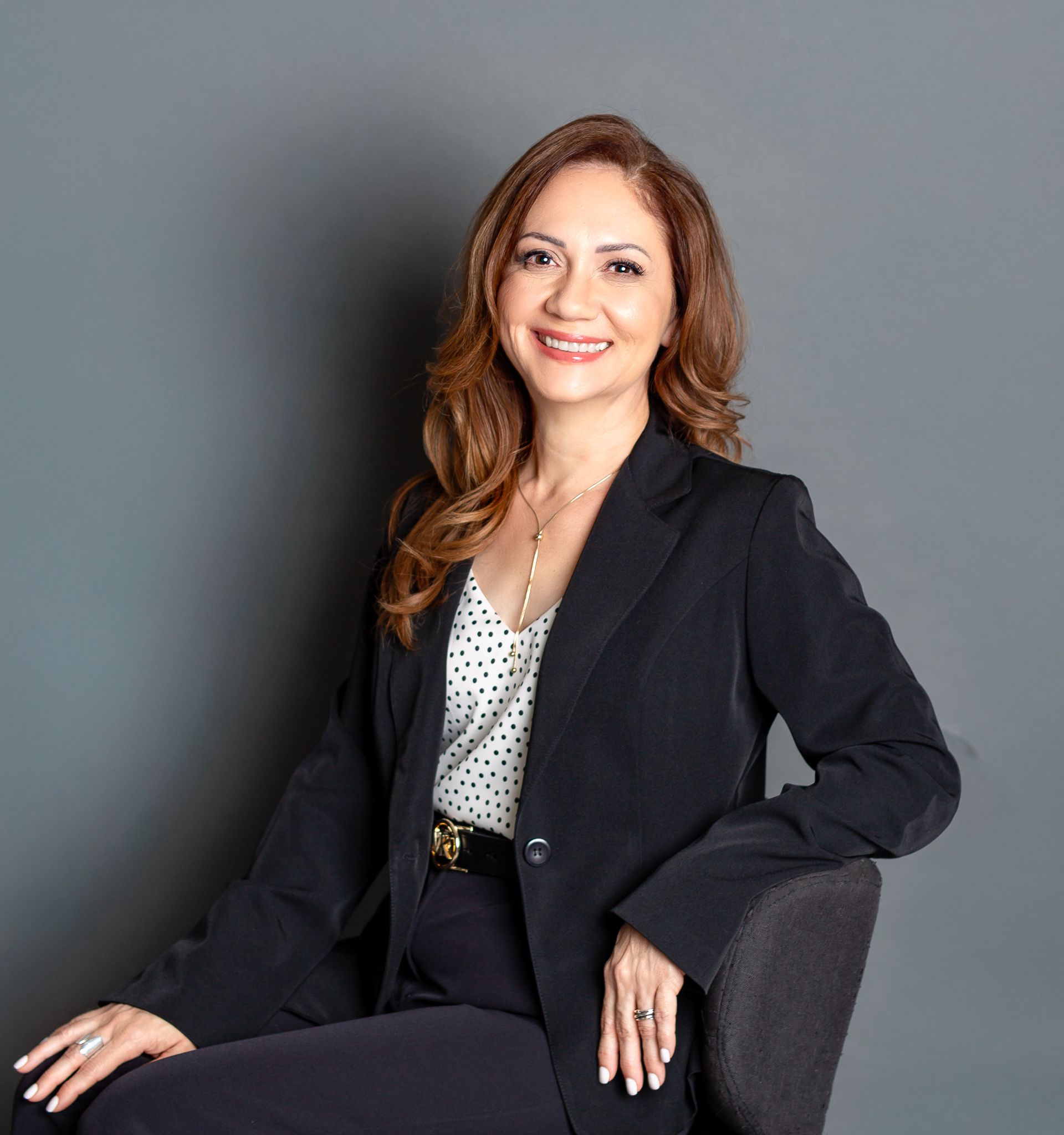 Business headshots against grey backdrop showing confident poses in black attire.
Personal branding.