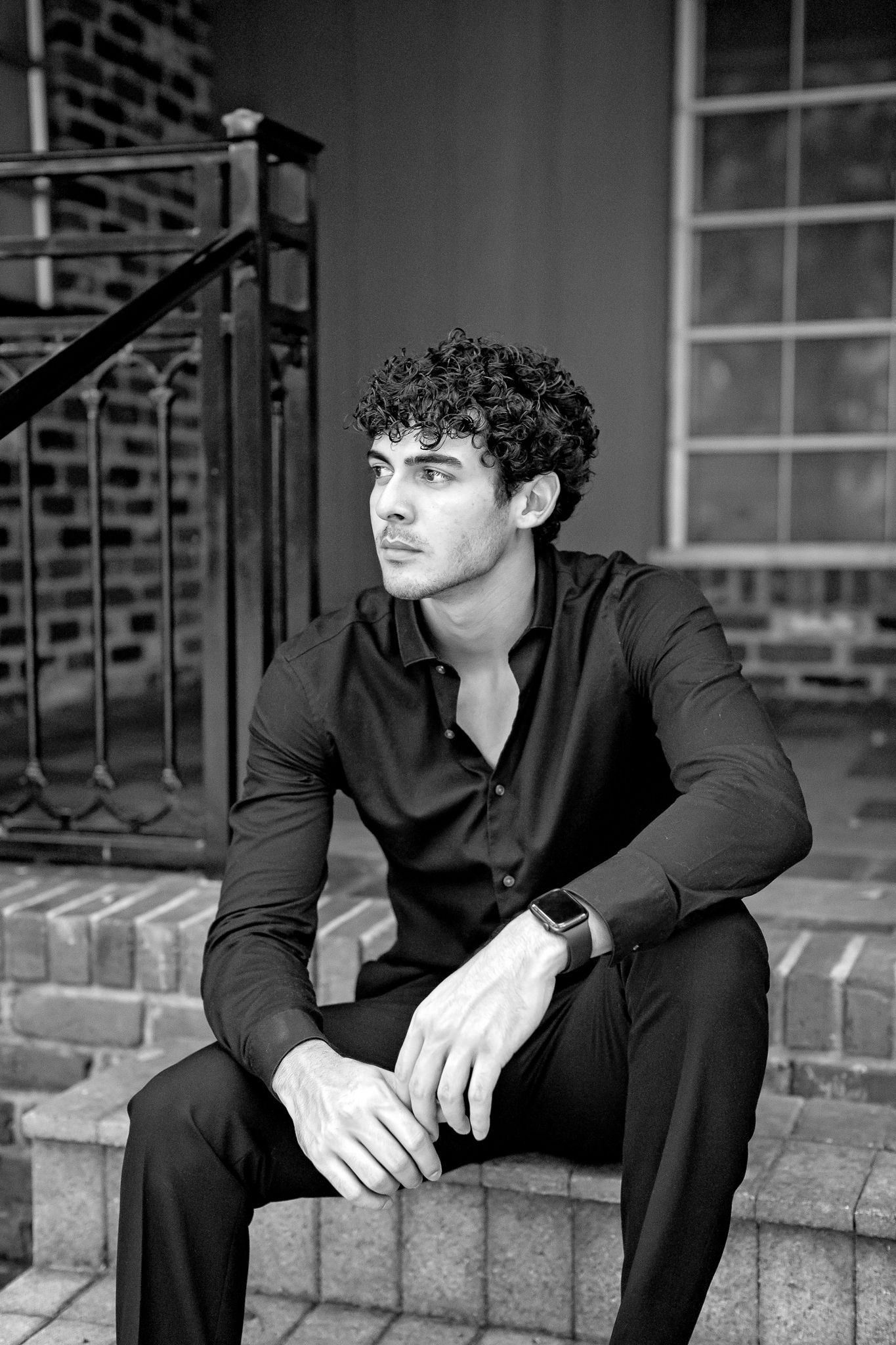 Monochrome portraits on brick steps showing contemplative poses in dark attire.
Personal branding. Senior session.