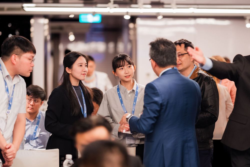 Business professionals engaging in lively conversation at a corporate networking event.
