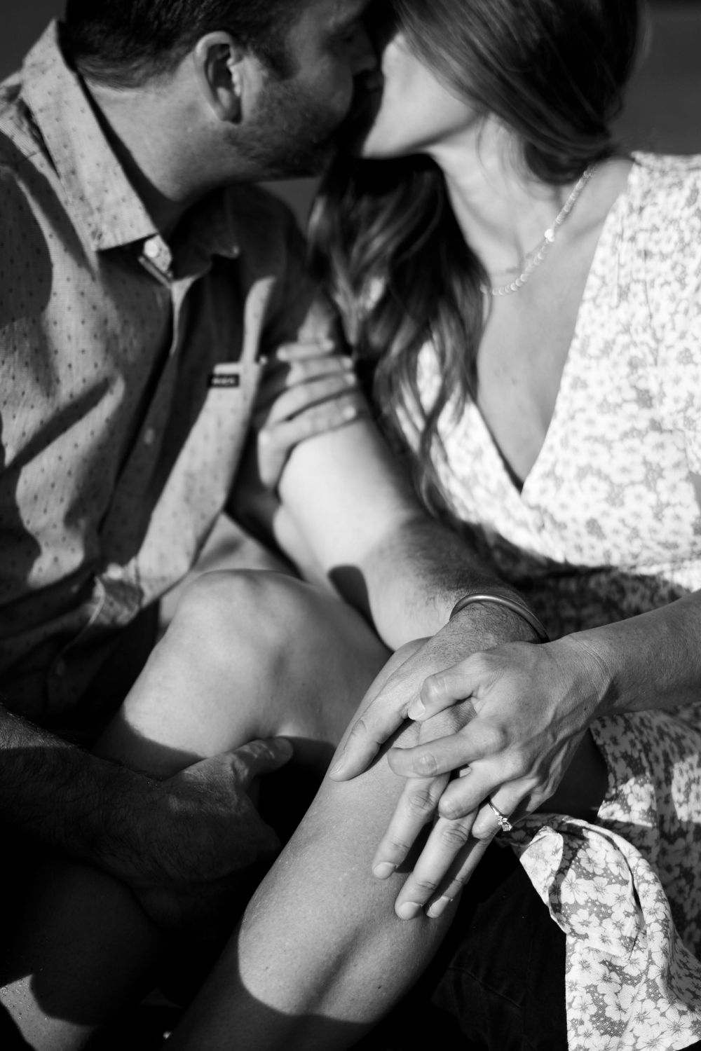 Romantic black and white photo series showing intimate moments between a couple in formal attire.