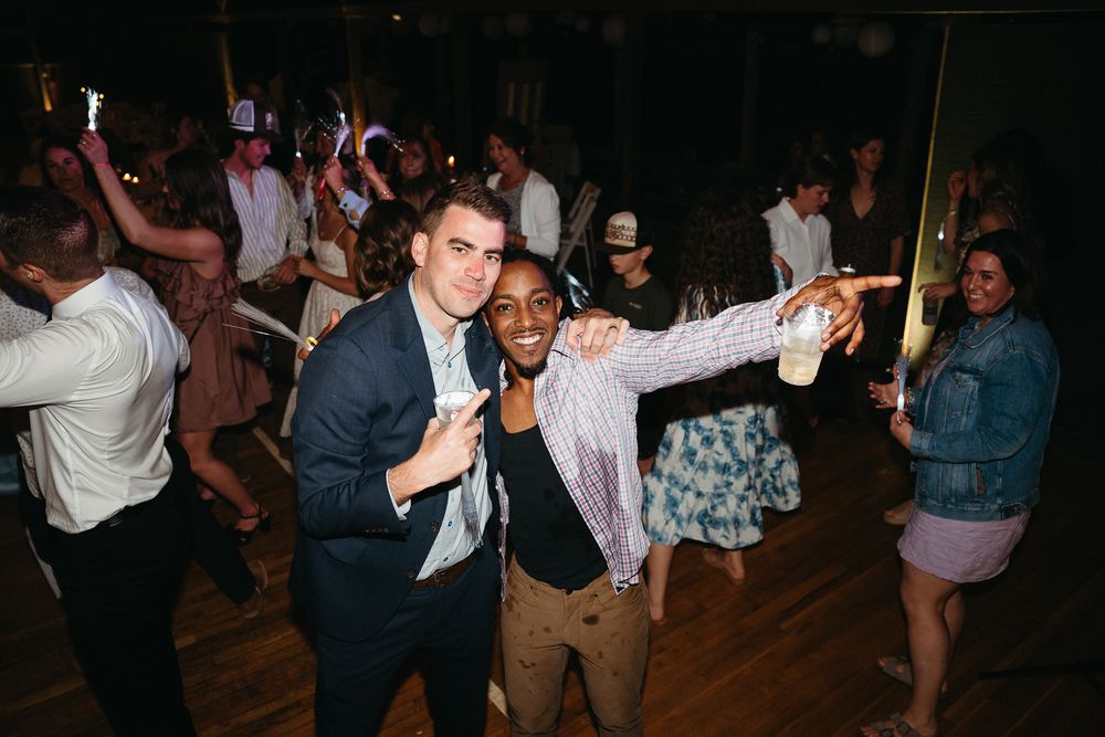 Guests enjoying themselves on a crowded dance floor at an evening wedding reception. Asheville, NC Wedding Photographer