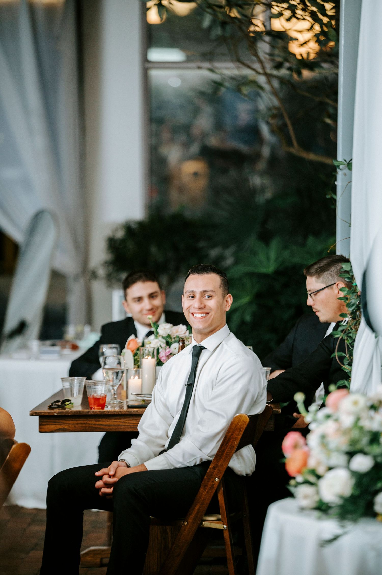 Wedding reception venue with white drapes and warm lighting creating an intimate atmosphere.