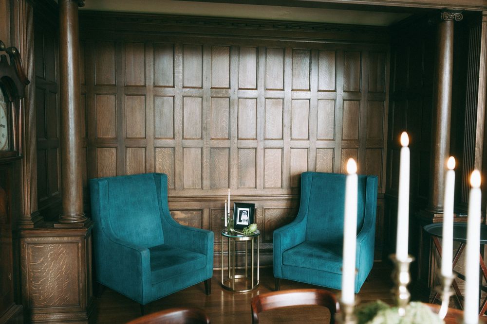 Wood paneled walls with ornate details stretch across a grand interior space.