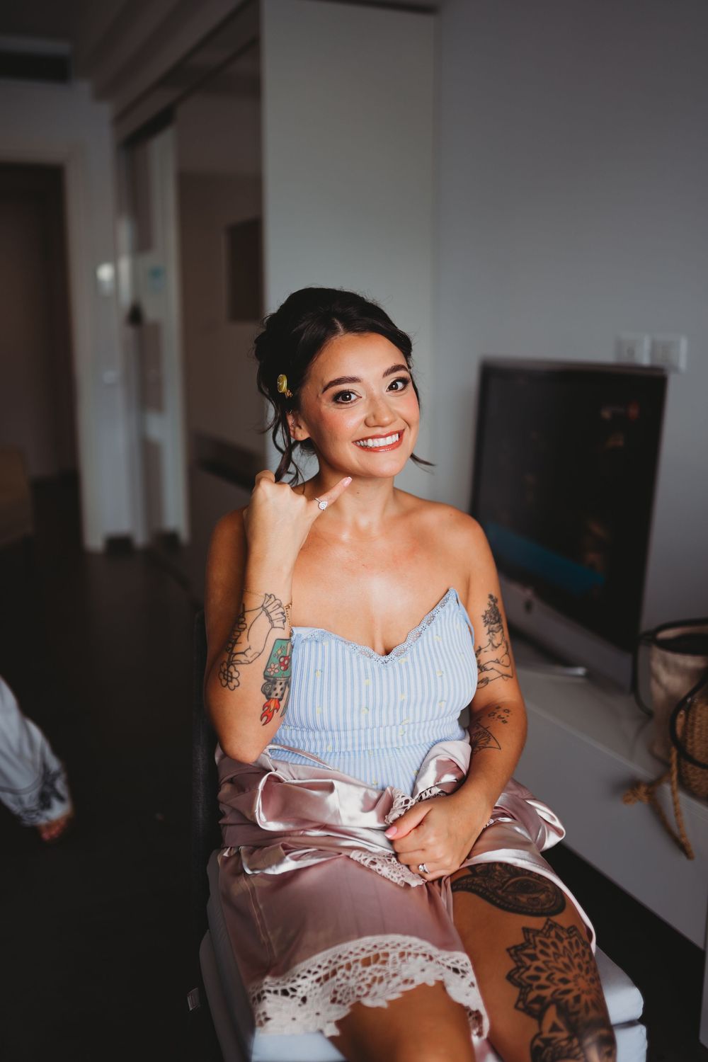 Getting ready scene with makeup application in a bright room.