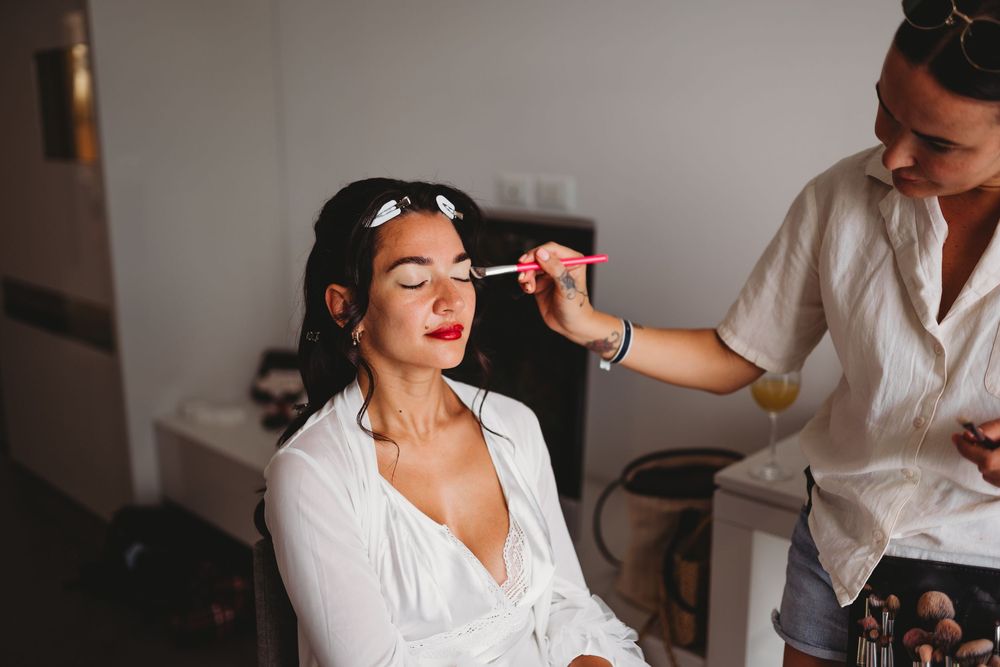 Wedding morning preparations with hair and makeup styling.