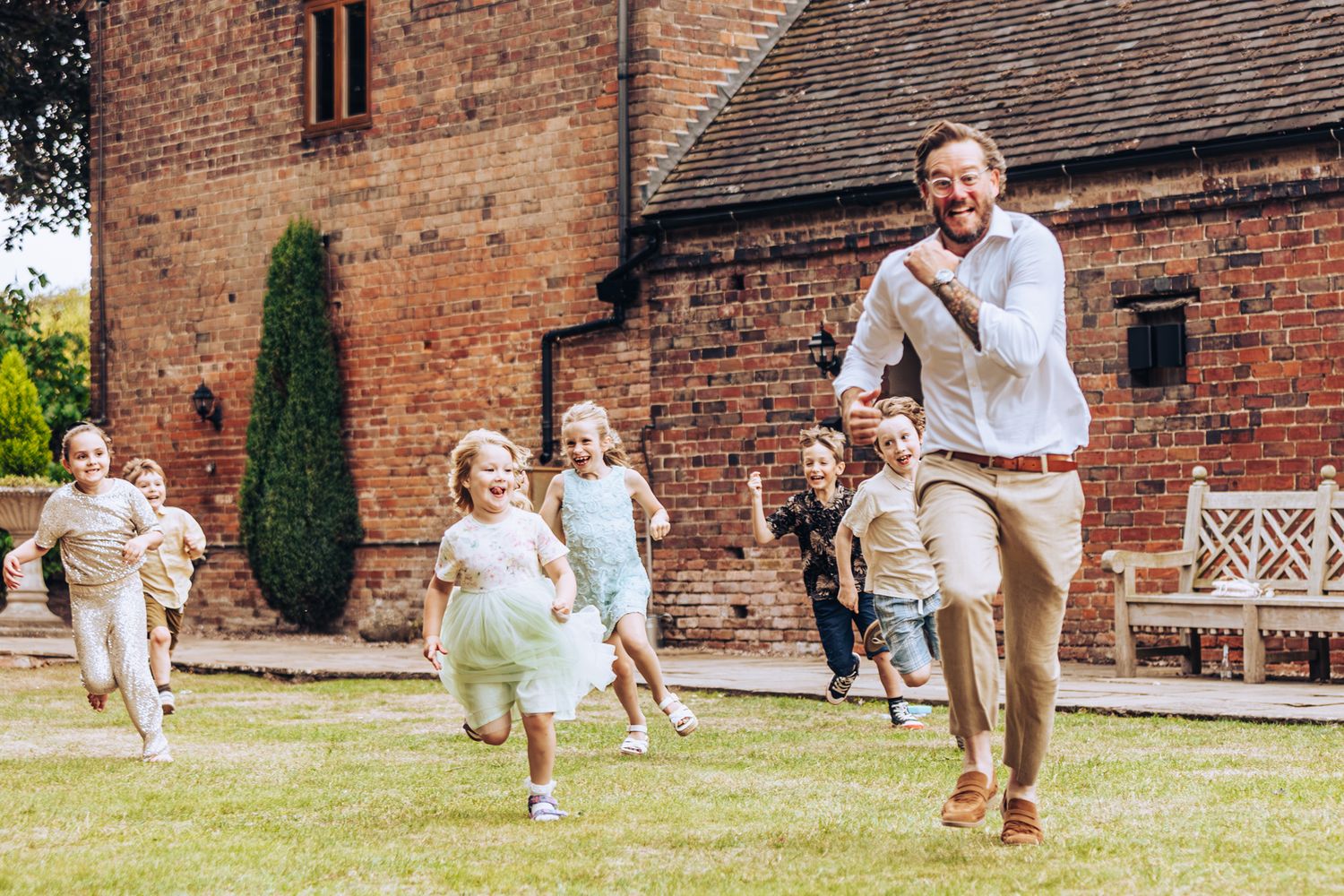 A sequence of photos showing a toddler running across a brick courtyard while being chased by an adult.