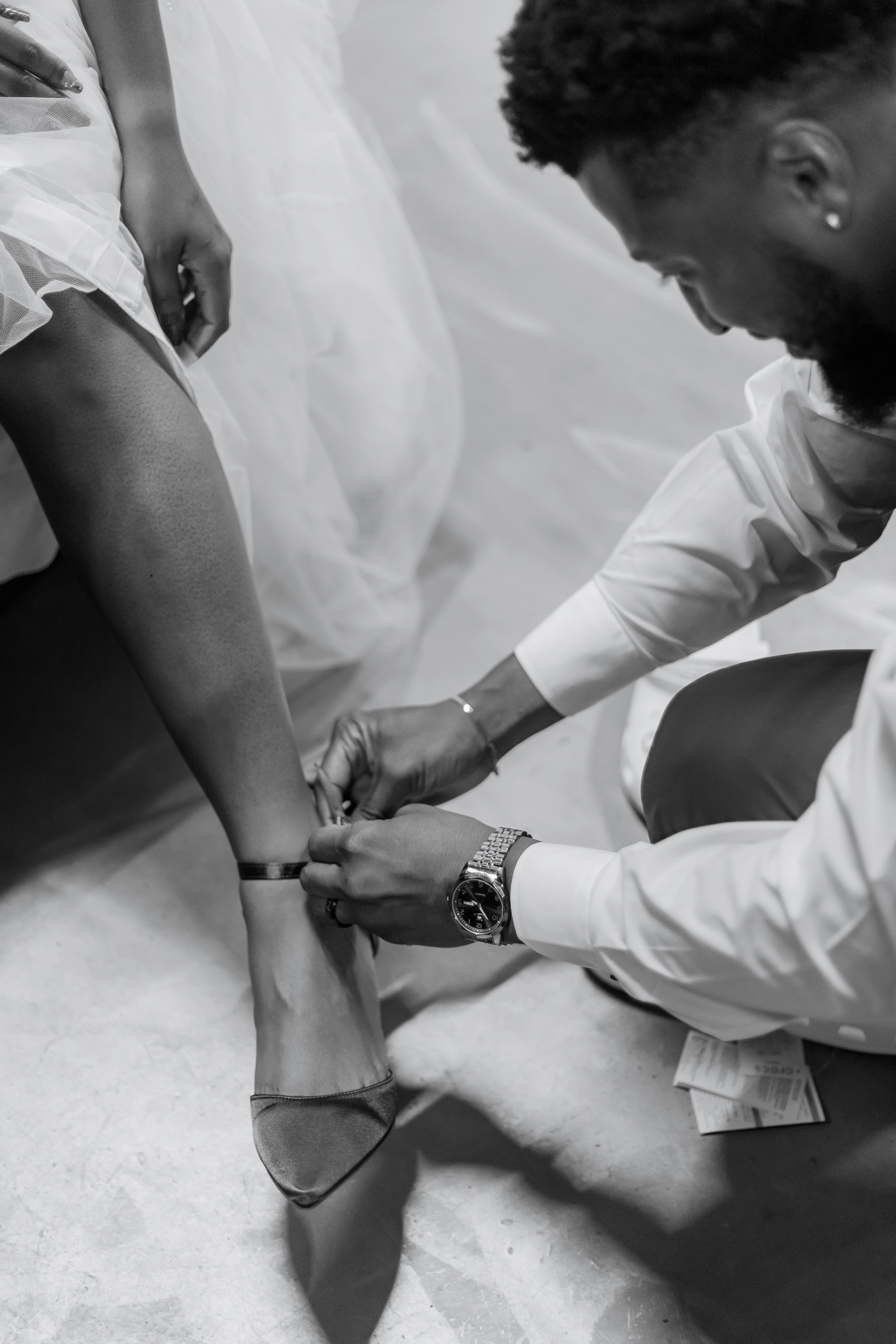 Healthcare professionals in white uniforms perform medical procedures in a series of black and white photographs.