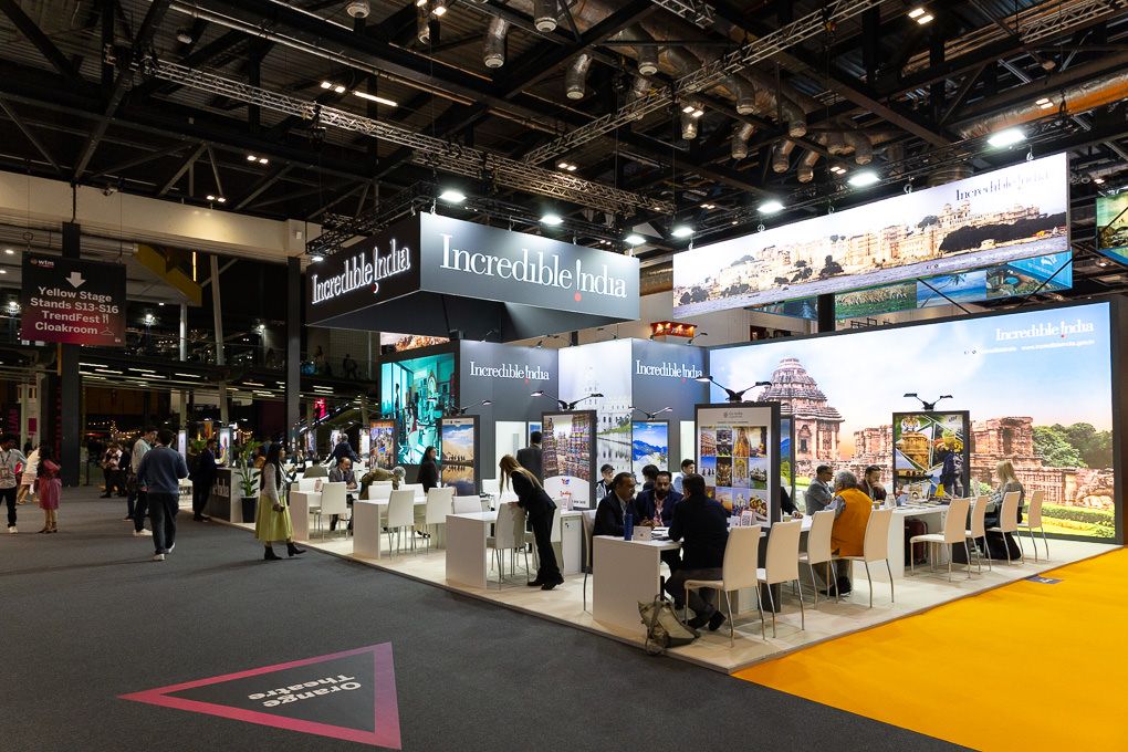 The 2025 WTM conference hall with multiple booths and displays featuring illuminated signage and exhibits.