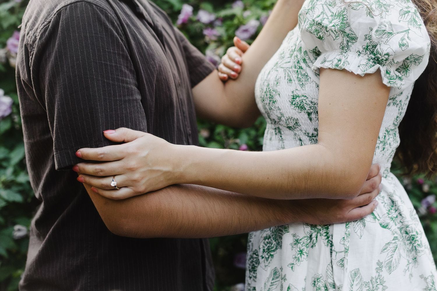 Romantic couple embrace shown in intimate cropped detail shots against garden background.