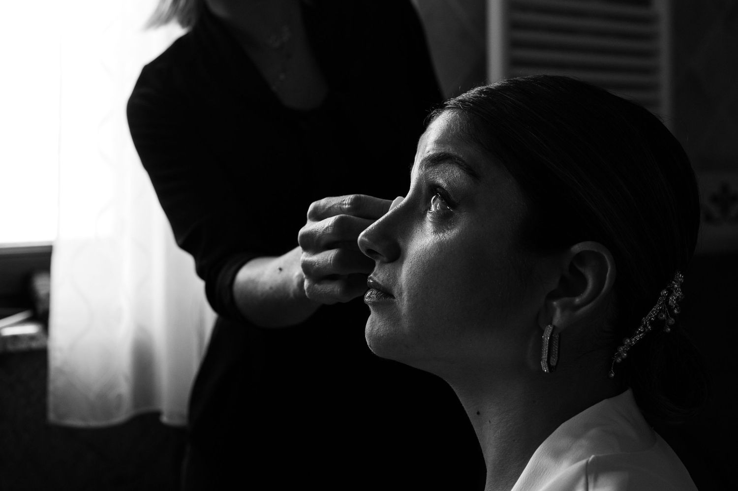 Dramatic black and white portrait series showing bridal preparation moments.