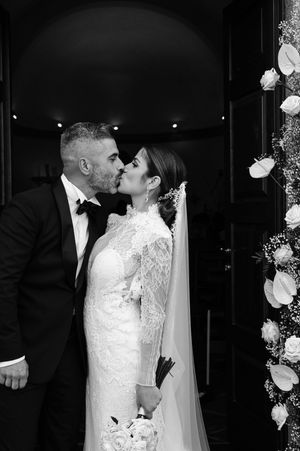 Black and white wedding portraits showing intimate moments between newlyweds.