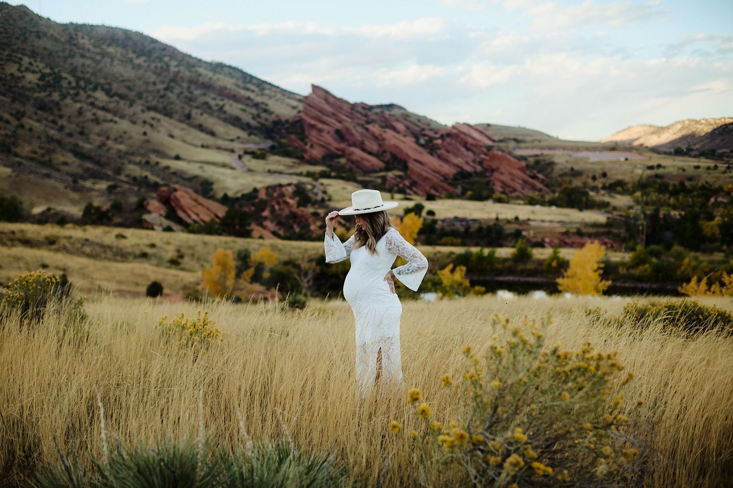 Maternity photo of expectant mother in lace dress at Mt Falcon East Denver Colorado