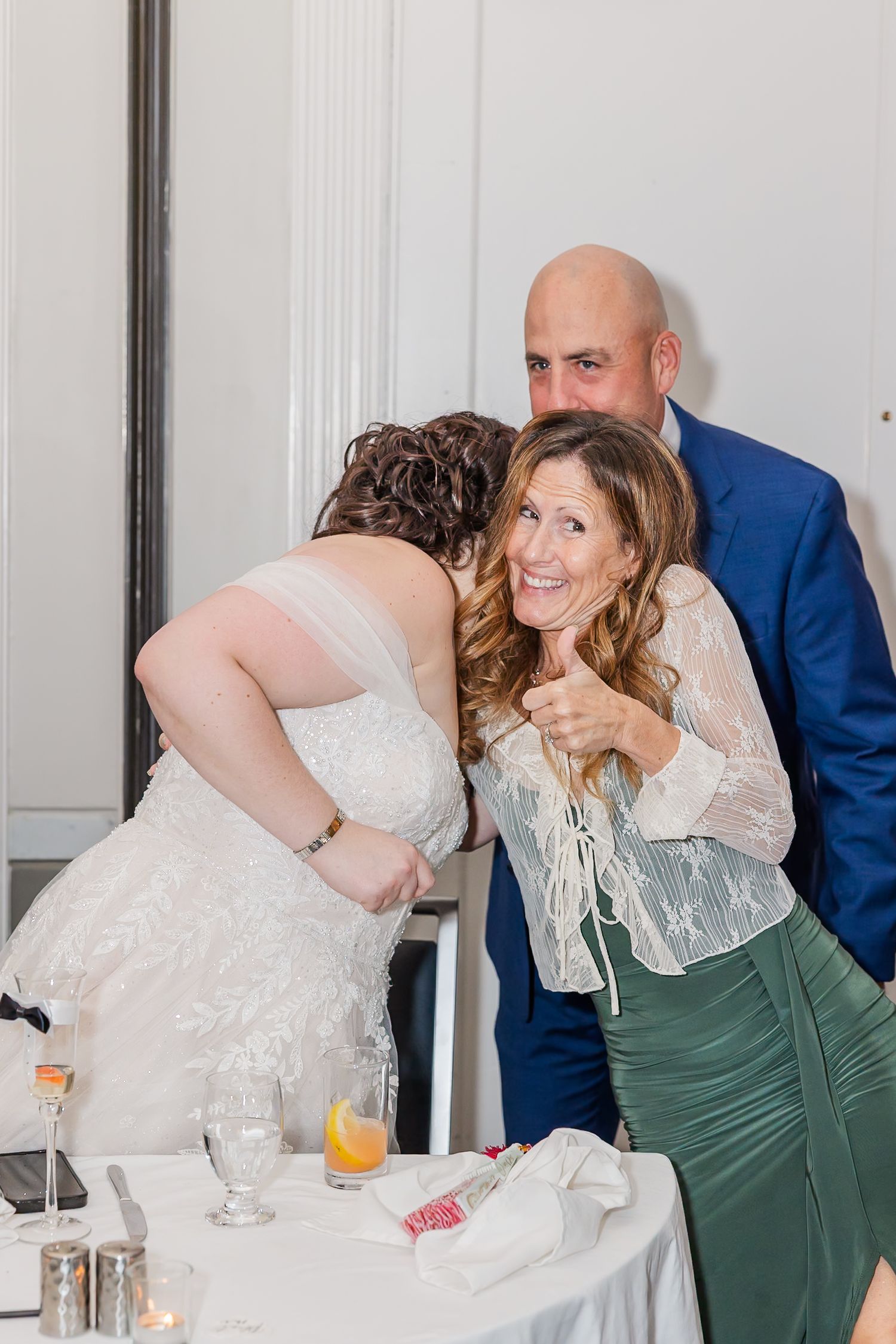 A sequence of wedding reception photos showing a couple sharing intimate moments while dining at their celebration table.