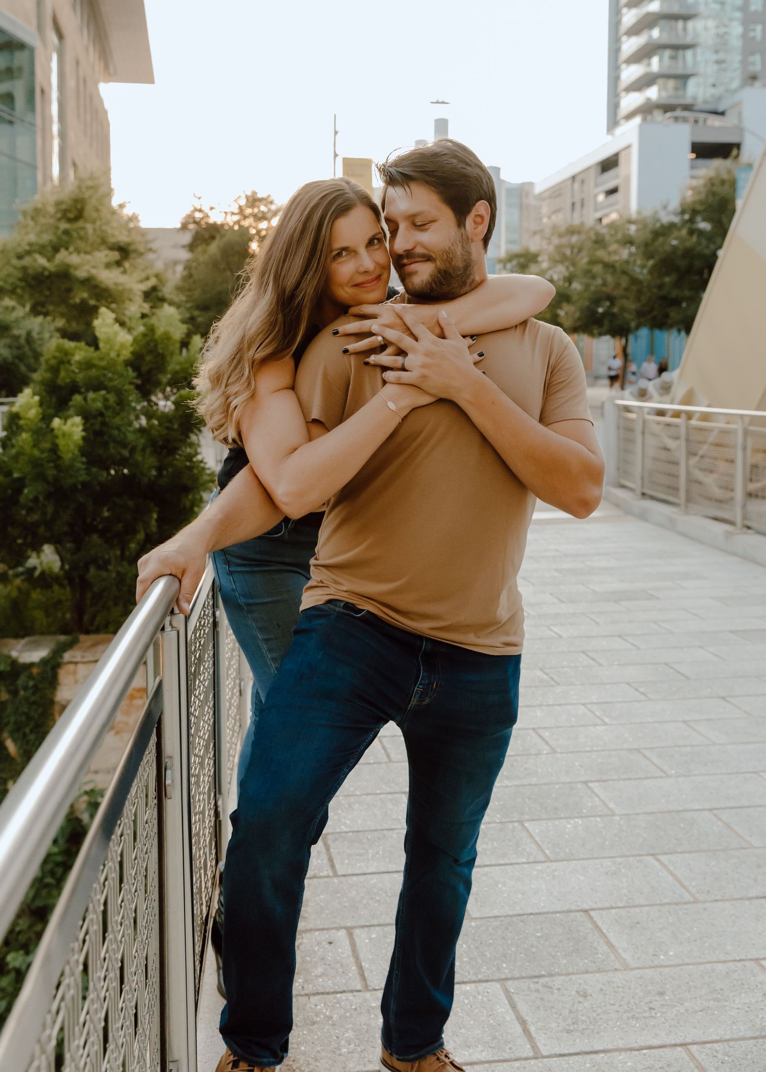 Couple dancing and laughing on outdoor terrace with Austin, TX city view