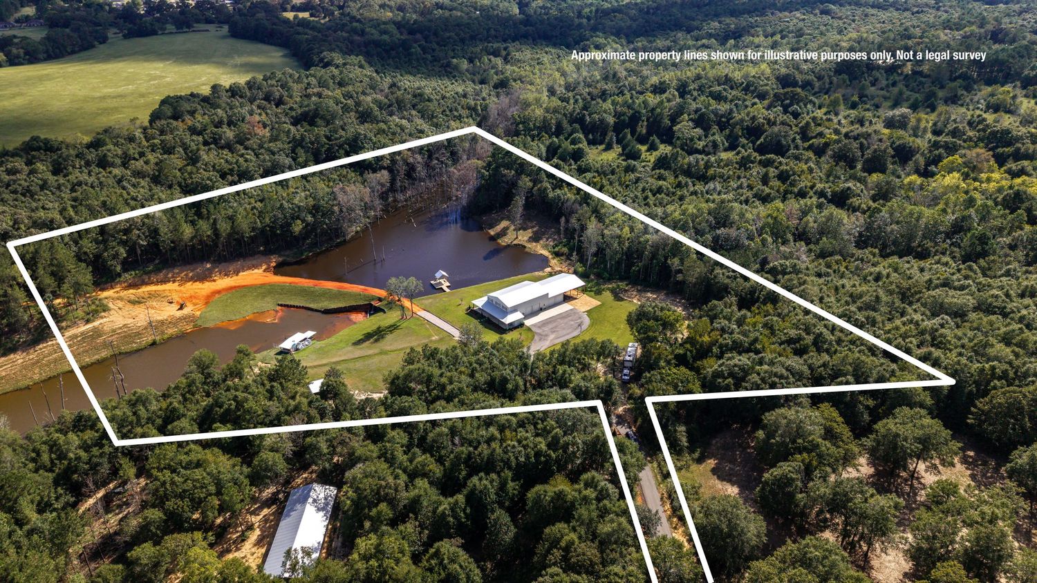Aerial view of a rural airstrip runway surrounded by farmland and forests stretching into the distance.
