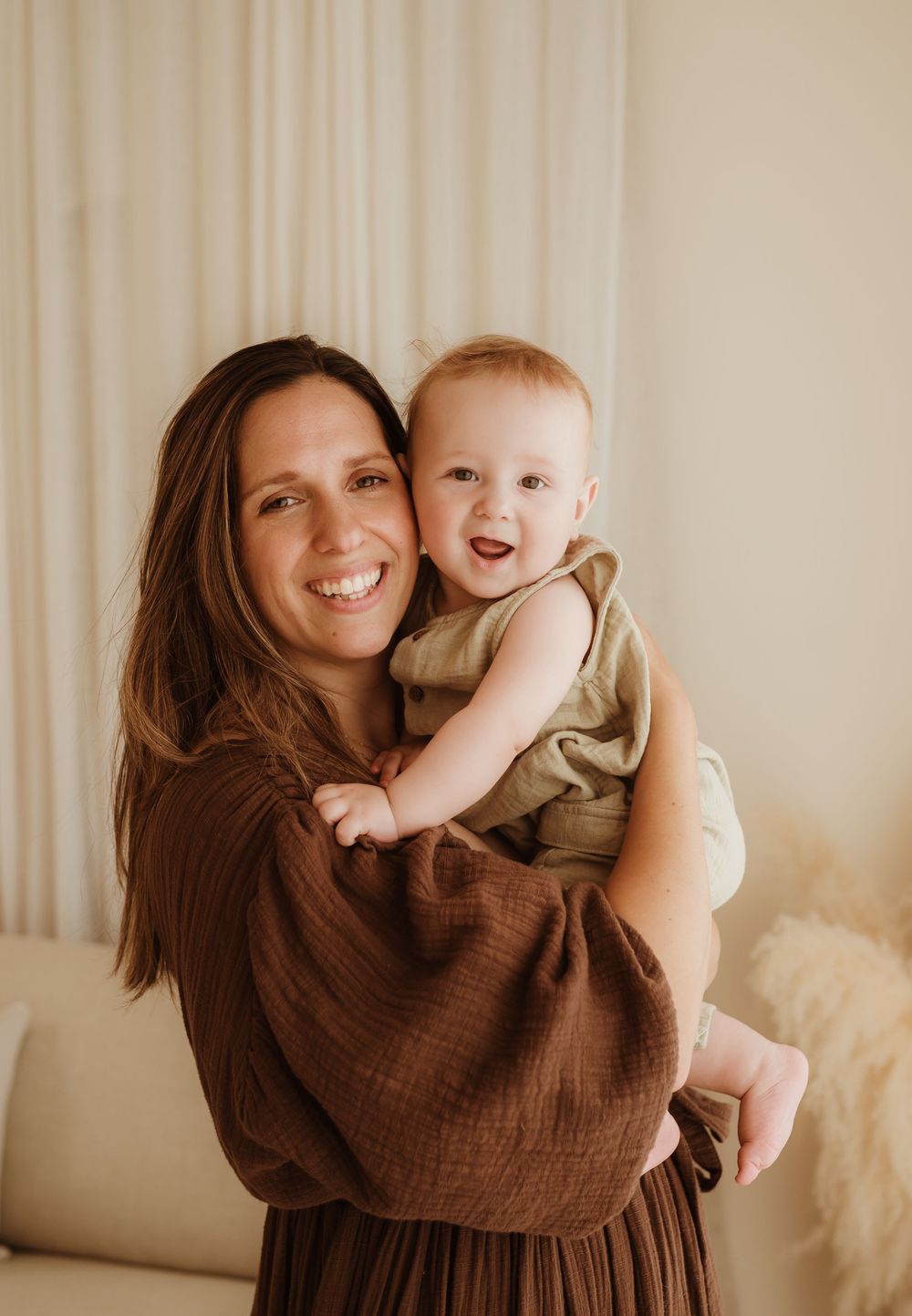 A joyful moment between parent and baby captured in a warm brown-toned series of candid photos.