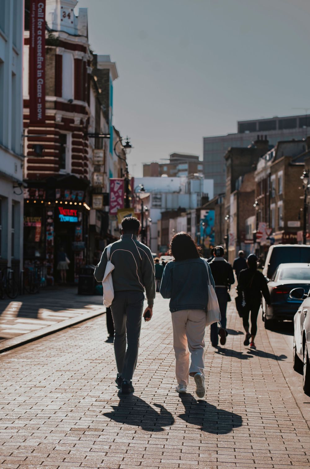 Two people taking a stroll mid afternoon in Lower Marsh, London by Shayla Bloom Photography