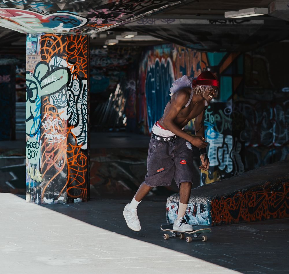 Male skateboarder skating at South Bank Skate Park in London by Shayla Bloom Photography