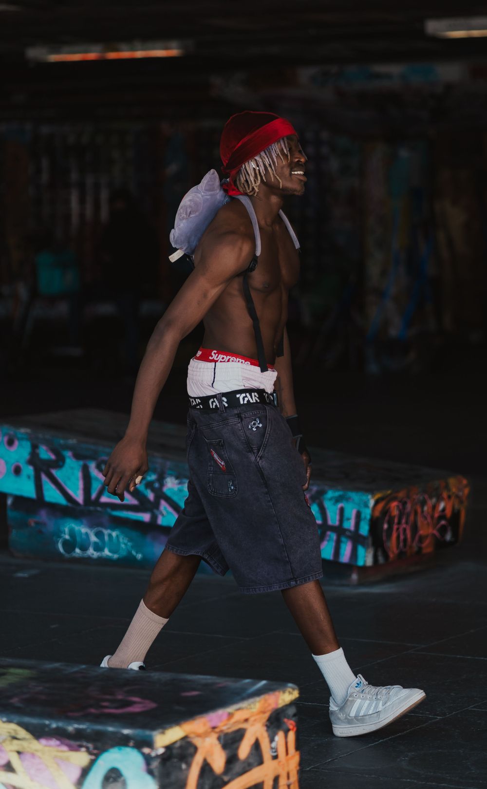 Skater walking across South Bank Skate park in London by Shayla Bloom Photography