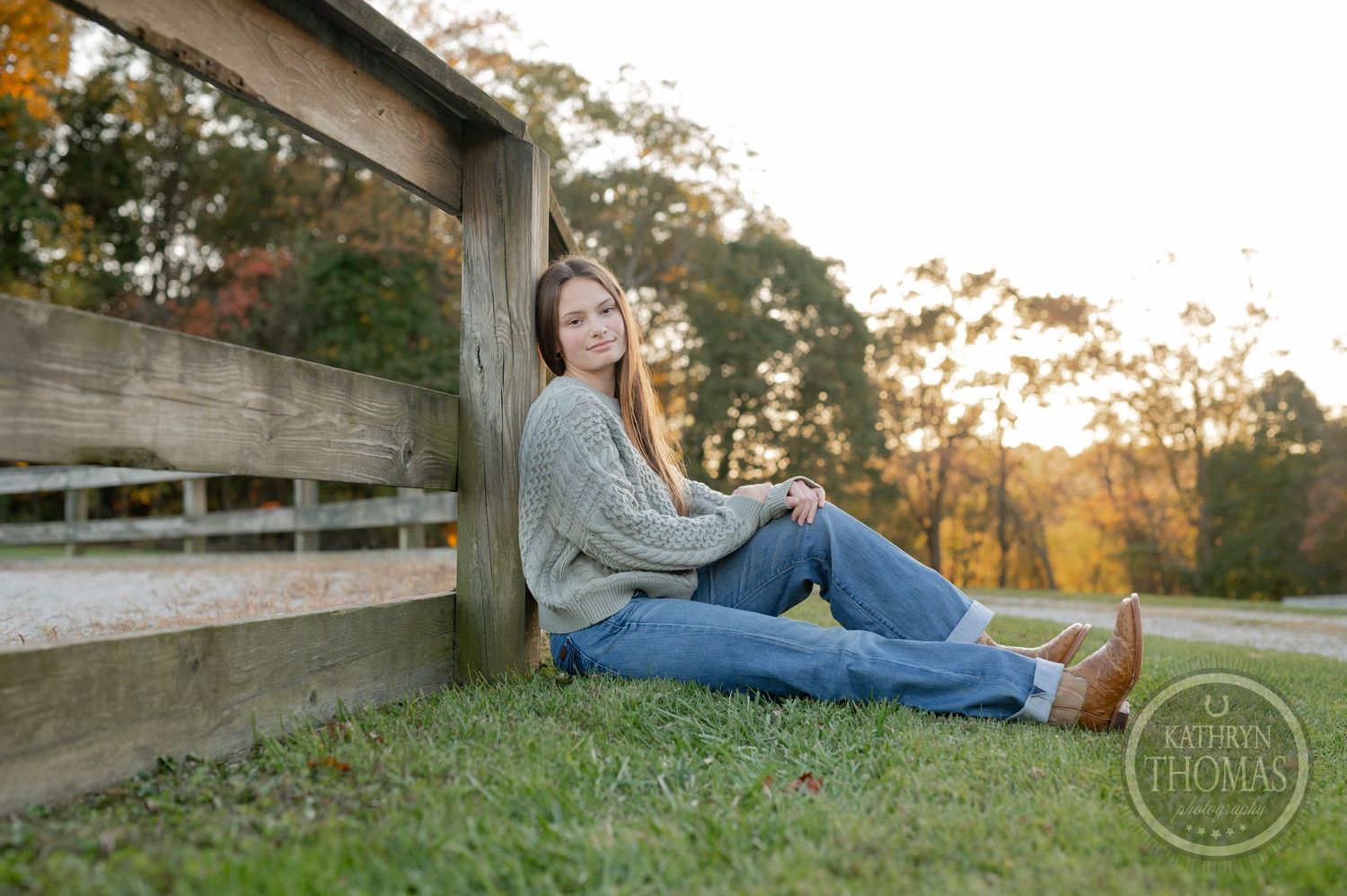 A casual portrait of someone relaxing against wooden bleachers during golden hour.