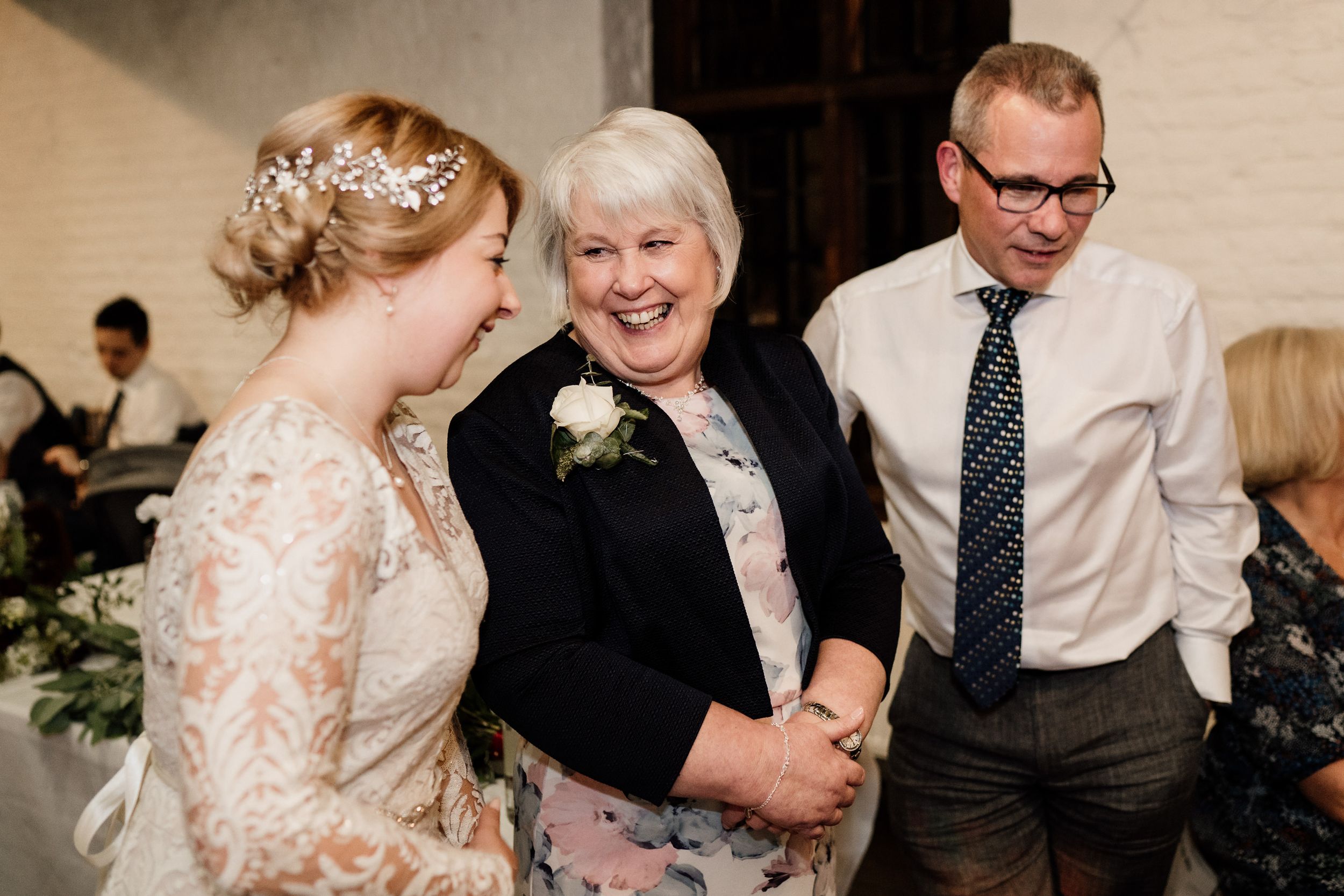 A joyful moment shared between celebration attendees during a wedding reception.