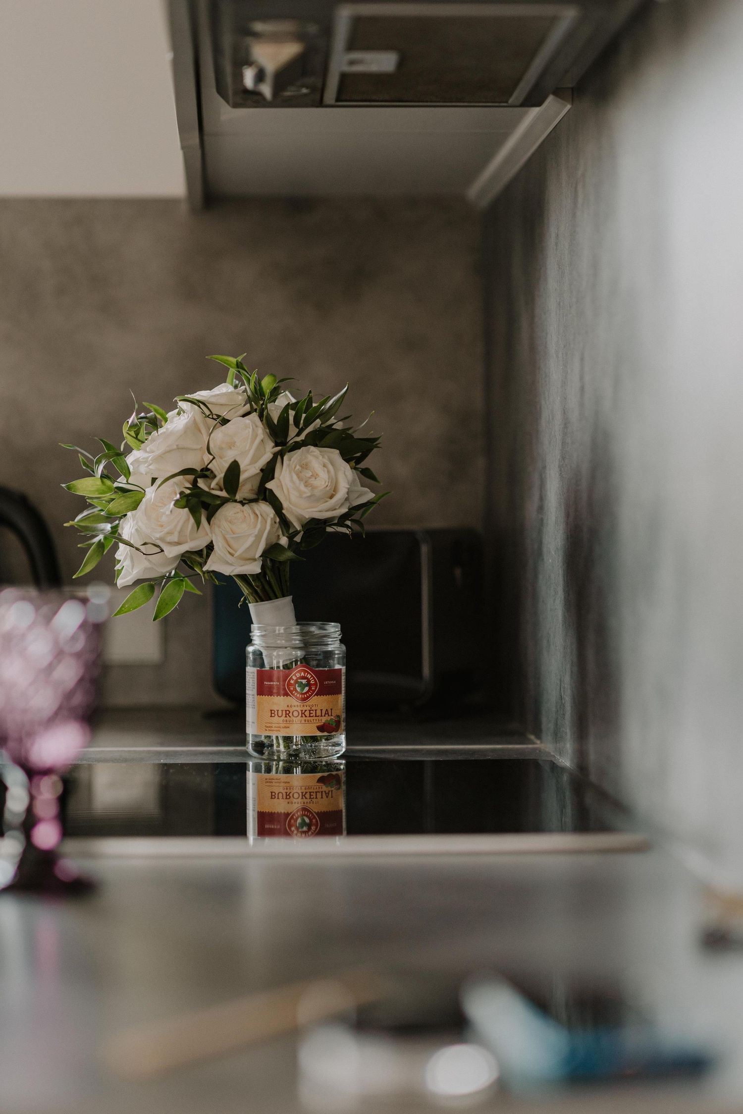 Elegant white floral arrangements in glass vases displayed on a neutral surface.