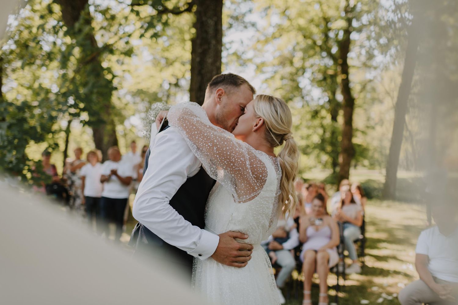 Happy couple sharing a dance moment during outdoor wedding celebration.