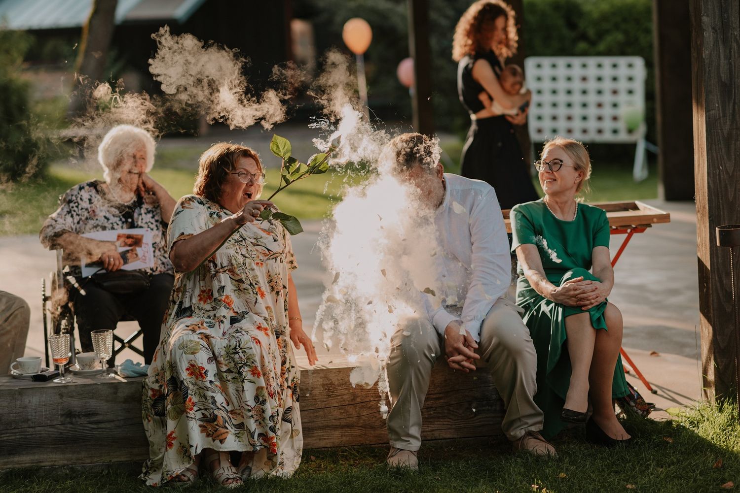 Wedding guests enjoying a sparkler moment during outdoor celebration.