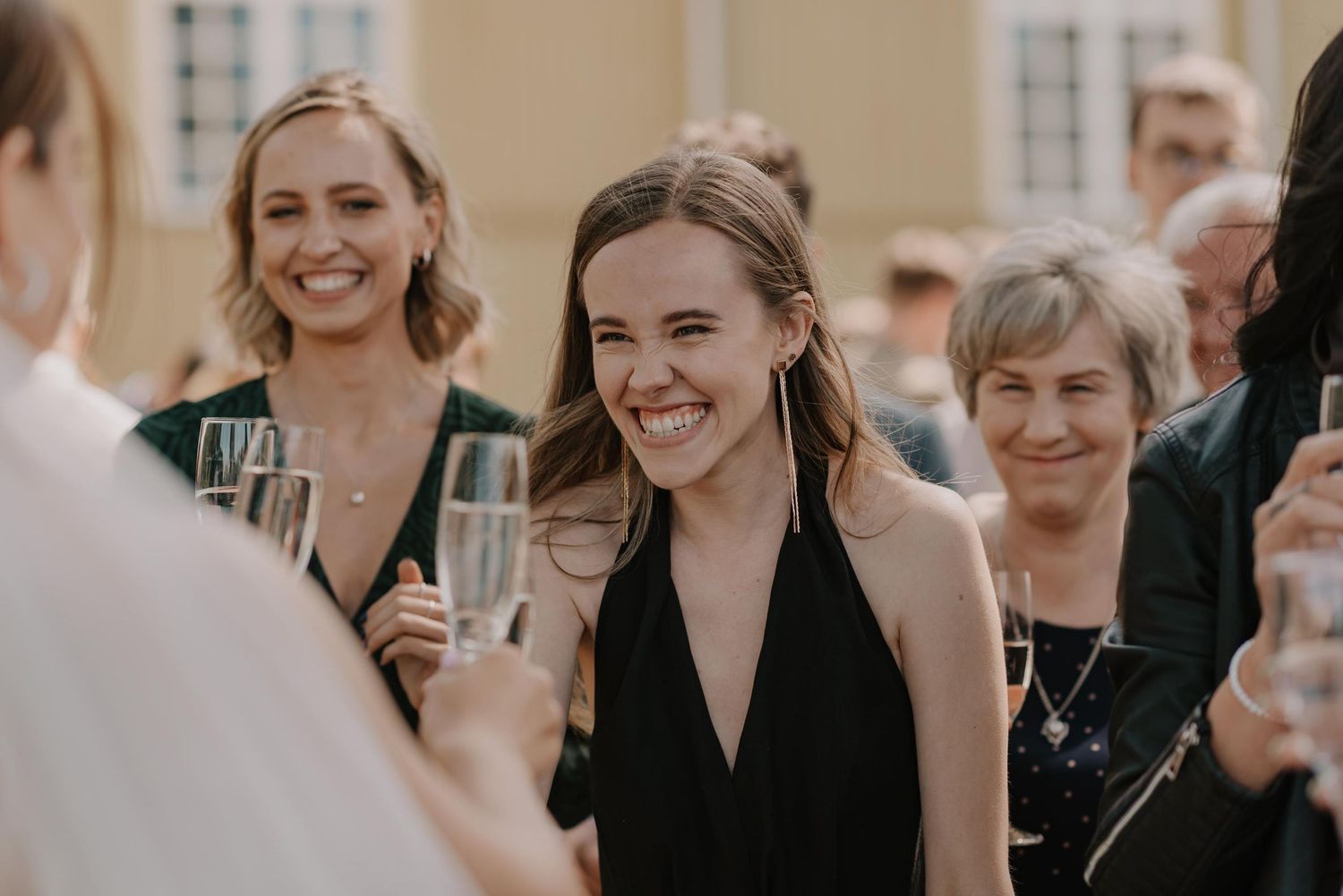 Candid moments captured during outdoor wedding festivities with guests in formal attire.