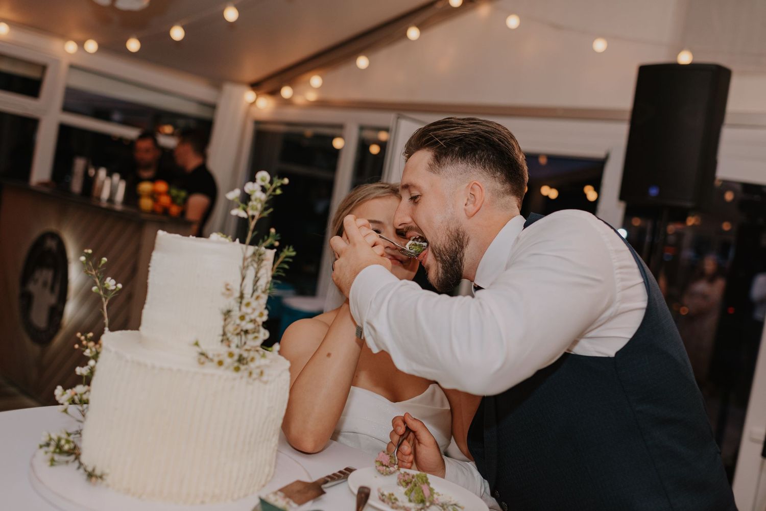 Romantic wedding reception venue with string lights and warm ambiance creating an intimate atmosphere.