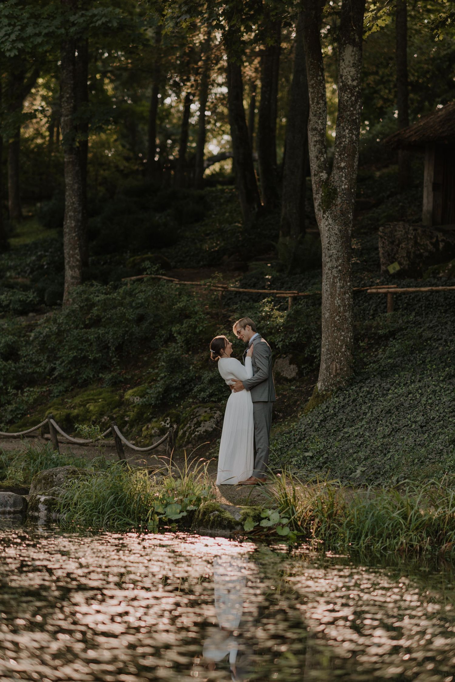 A romantic forest path lined with trees creates a dreamy setting for wedding photography.