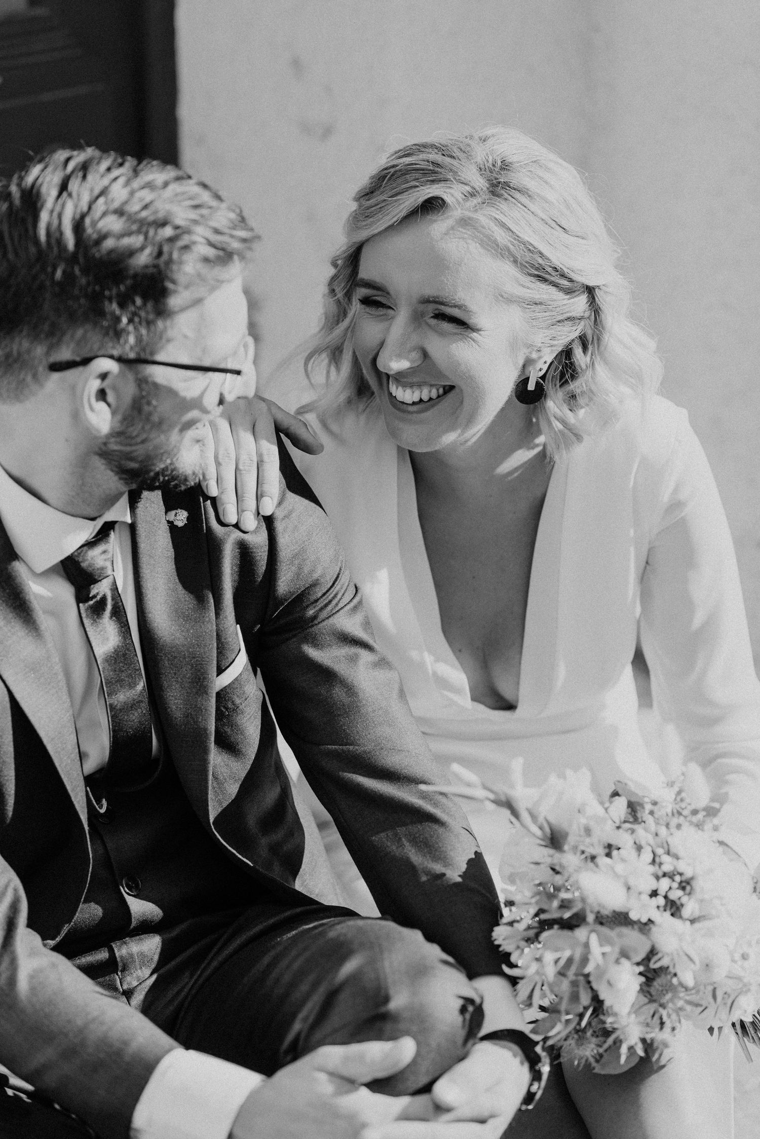 Black and white series of candid laughter and joy between a wedding couple.