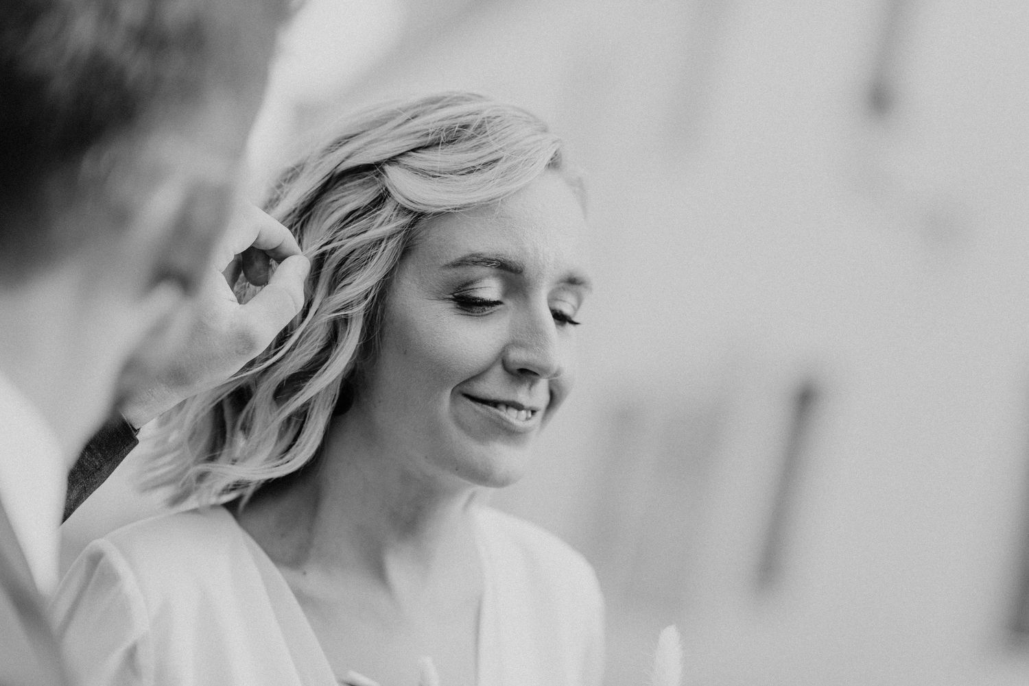 Black and white wedding portraits showing candid emotional moments.